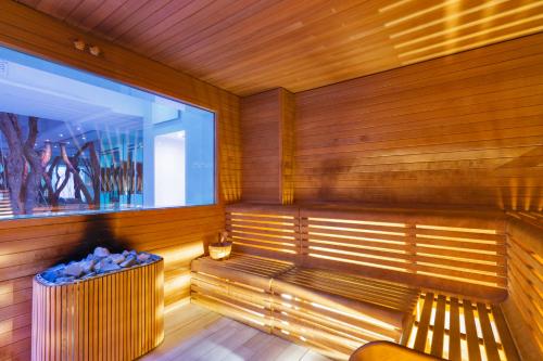 a room with a wooden floor and a large window at Victoria Palace Hotel & Zen Wellness in Gallipoli