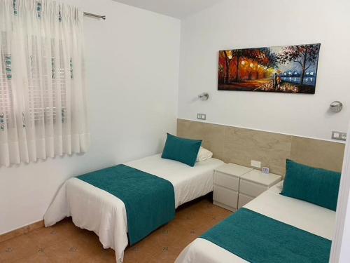 En eller flere senge i et værelse på Rosa Golf