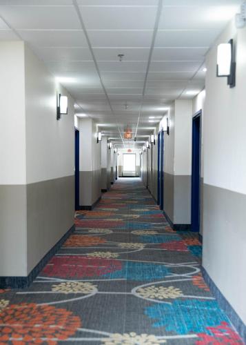 an empty hallway in a building with ailed floor at Econo Lodge Near Fort Gregg-Adams I-295 in Hopewell