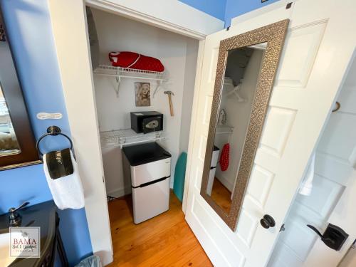 a small closet with a mirror and a sink at Bama Bed and Breakfast - Chimes Suite in Tuscaloosa