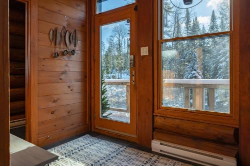a room with a door and a window at 4-Bedroom Chalet Fraternite in Lac-Superieur Tremblant in Lac-Superieur