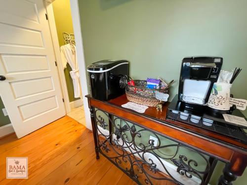 a table with a coffee maker on top of it at Bama Bed and Breakfast - Tusk Suite in Tuscaloosa