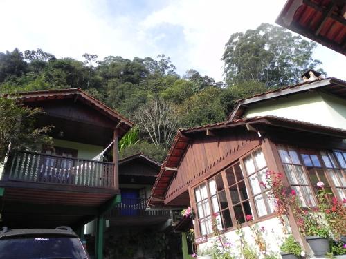 a group of houses with a car parked in front at Pousada Solar das Flores Maringá RJ Visconde de Mauá in Visconde De Maua