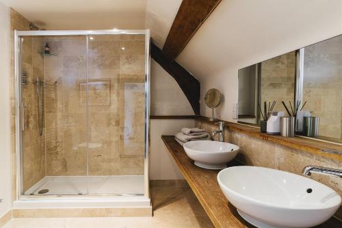 a bathroom with a shower and a sink and a tub at Weeke Barton in Exeter