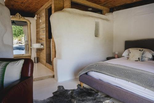a bedroom with a bed and a large window at Weeke Barton in Exeter