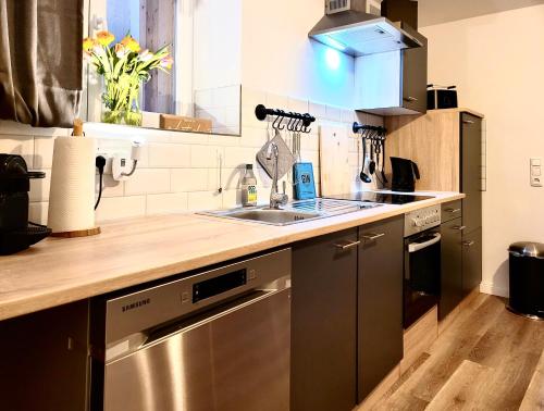 a kitchen with a sink and a counter top at Das Stader Quartier in Stade