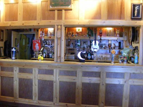 a large bar with a wooden counter top at Trevelyan Hotel in Douglas