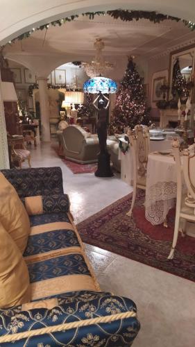 a living room with a christmas tree and a couch at Luxury B&B IL Sogno in Cerignola