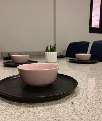 a table with bowls on a plate on a table at Atrani in Santeagueda