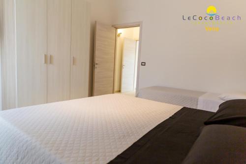 Ein Bett oder Betten in einem Zimmer der Unterkunft Le Coco Beach Apartaments