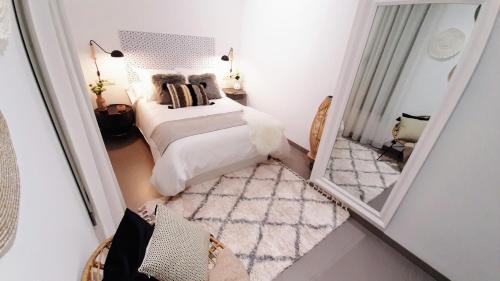 a bedroom with a bed and a mirror at Home VIP - Vivienda de Lujo con todo detalle in Casas Ibáñez