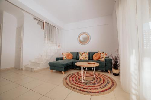 a living room with a couch and a table at Calas Sani Villas in Filakaí Kassándras