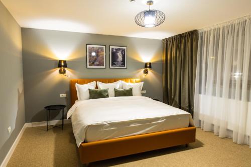 a bedroom with a large bed in a room at UpperHouse Suites & More in Braşov