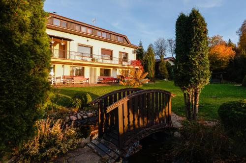 a large house with a bridge in front of it at Willa MM Kaszuby in Łapalice