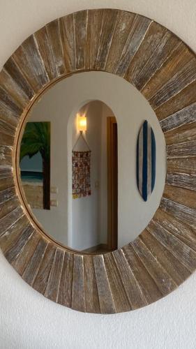 a circular mirror on a wall in a room at Sal Apartments Djadsal Moradias in Santa Maria