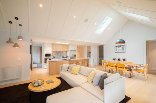 a living room with a white couch and a table at Millbrook Resort in Arrowtown