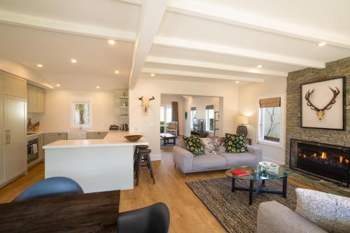 a living room with a couch and a fireplace at Millbrook Resort in Arrowtown