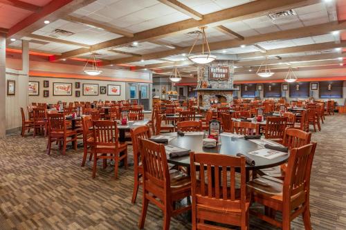 a dining room with wooden tables and chairs at Holiday Inn Rockford by IHG in Rockford