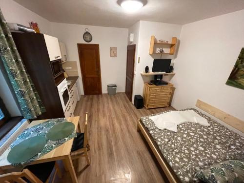 a small room with a bed and a table in it at Chalupa Jáchymov - ubytování v srdci Krušných hor in Jáchymov