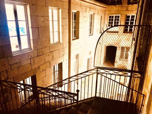 a stairway leading to a building withwindows and a stair case at Les Tiercelines in Dole
