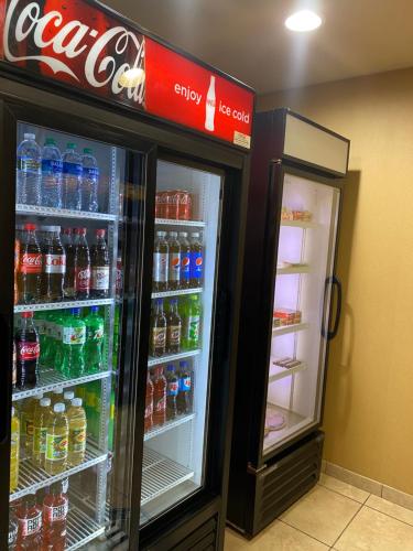 two refrigerators in a store with soda and sodas at Cobblestone Hotel & Suites - Broken Bow in Broken Bow