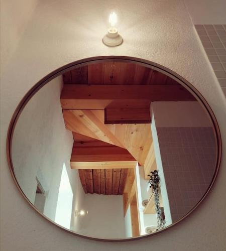 a mirror reflecting a wooden staircase in a room at Weinstöckl in der Südsteiermark in Leutschach