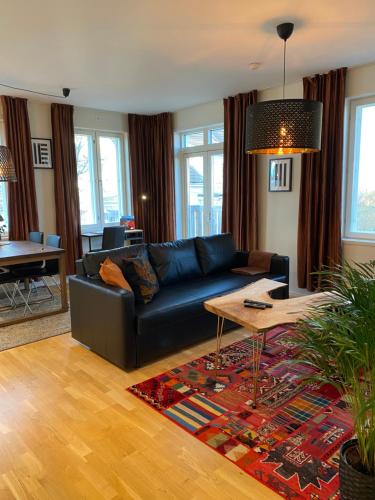 a living room with a couch and a table at Stava Mosters in Mariehamn