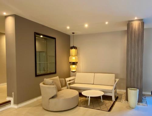 a living room with a couch and a table at Serena Hotel - Punta del Este - Unico sobre la Playa in Punta del Este