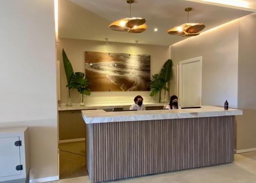 two people sitting at a bar in a room at Serena Hotel - Punta del Este - Unico sobre la Playa in Punta del Este