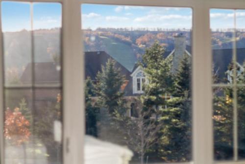 a view of a house from a window at Modern home with a pool sauna pooltable & mountain view in Collingwood