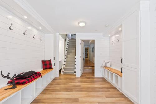 a hallway of a home with white walls and wood floors at Paradise Manor w Hot tub Sauna & Putting Green in Blue Mountains