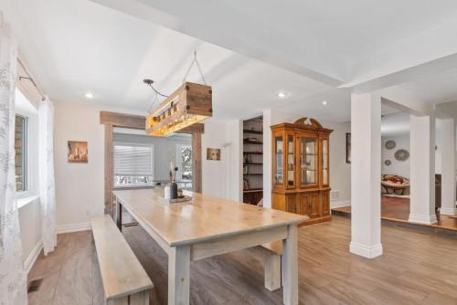 a kitchen with a wooden table in a room at Paradise Manor w Hot tub Sauna & Putting Green in Blue Mountains