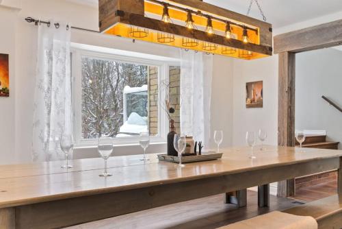 a dining room with a table with wine glasses on it at Paradise Manor w Hot tub Sauna & Putting Green in Blue Mountains
