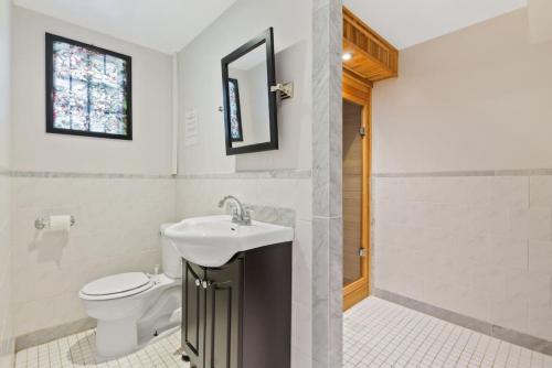 a bathroom with a sink and a toilet at Paradise Manor w Hot tub Sauna & Putting Green in Blue Mountains