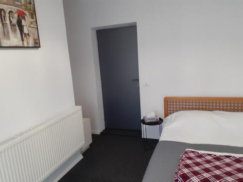 a bedroom with a bed and a door in a room at Salcia in Tăşnad