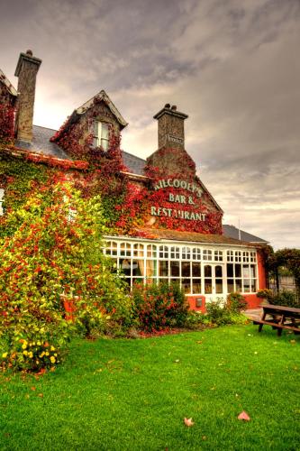 a building with a sign on the side of it at Kilcooly's Country House Hotel in Ballybunion