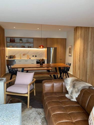 a living room with a couch and a table at Rata Boutique Apartments in Ohakune