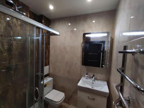 a bathroom with a toilet and a shower and a sink at Designer apartment in THE CENTER in Pyatigorsk