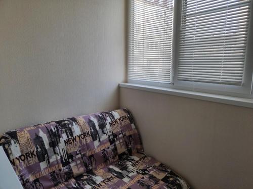 a couch in a room with a window at Designer apartment in THE CENTER in Pyatigorsk