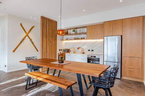 a dining room with a wooden table and chairs at Rata Boutique Apartments in Ohakune