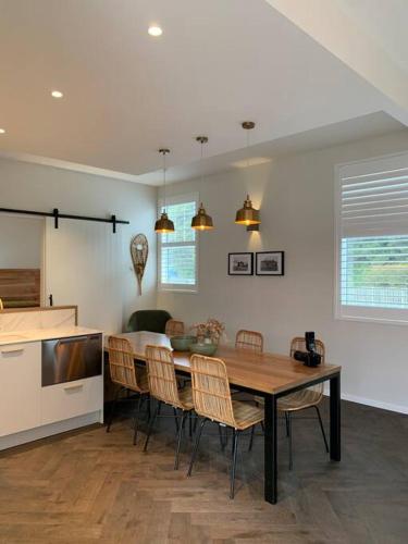 a kitchen and dining room with a table and chairs at Rata Boutique Apartments in Ohakune