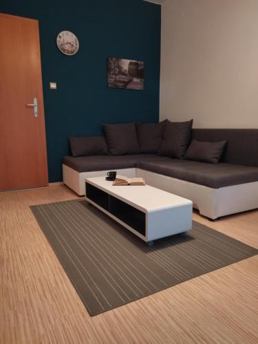 a living room with a couch and a coffee table at Apartments Sabo in Kraljevica