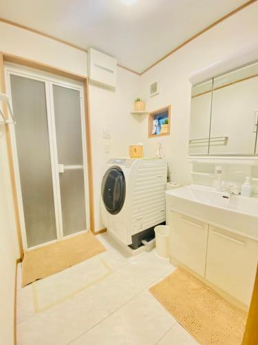 a bathroom with a sink and a tv in it at Private lodging in WEST TOKYO(SHINJUKU, TACHIKAWA, SANRIO, GHIBLI, MT. TAKAO etc) in Kokubunji