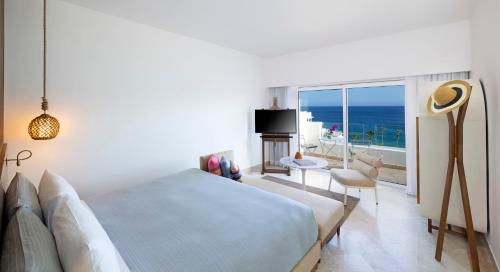 a bedroom with a bed and a view of the ocean at ME Cabo by Meliá in Cabo San Lucas