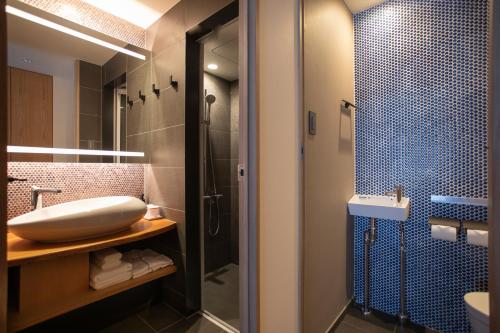a bathroom with a sink and a shower at Hotel Legasta Kyoto Higashiyama Sanjo in Kyoto
