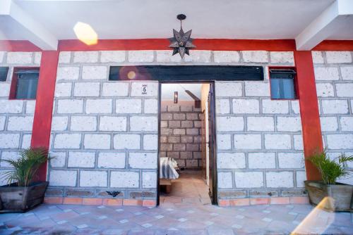 a brick building with a star on the wall at Rancho los olivos Habitaciones Campestres in San Miguel de Allende