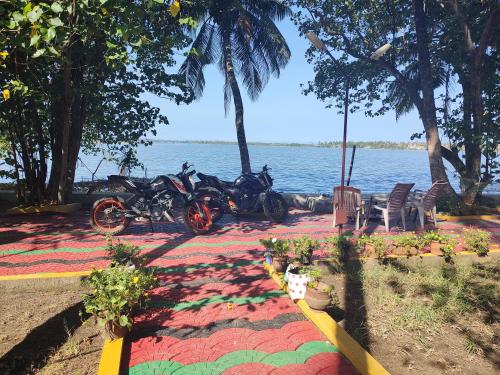 a group of motorcycles parked next to the water at West Wind Homez - Home Stay in Cochin