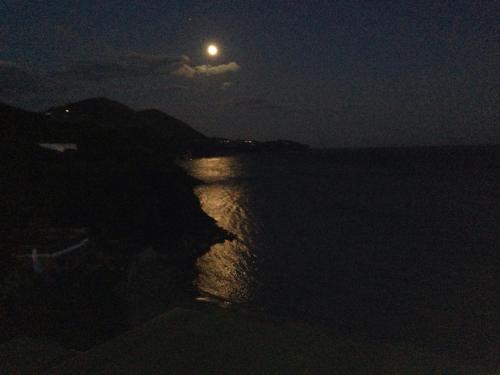 a full moon over the ocean at night at Summit Hotel in Gaeta