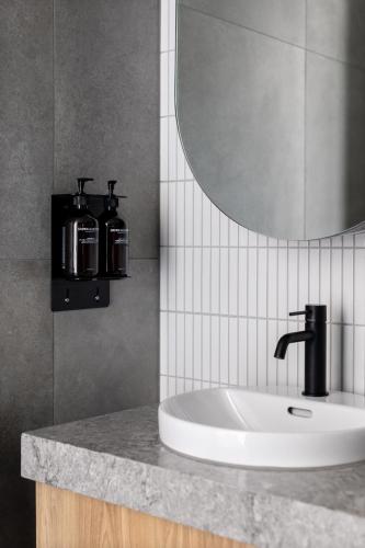 a bathroom with a sink and a mirror at Caroline Serviced Apartments Richmond in Melbourne
