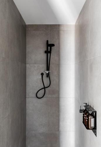 a bathroom with a shower with a hose at Caroline Serviced Apartments Richmond in Melbourne